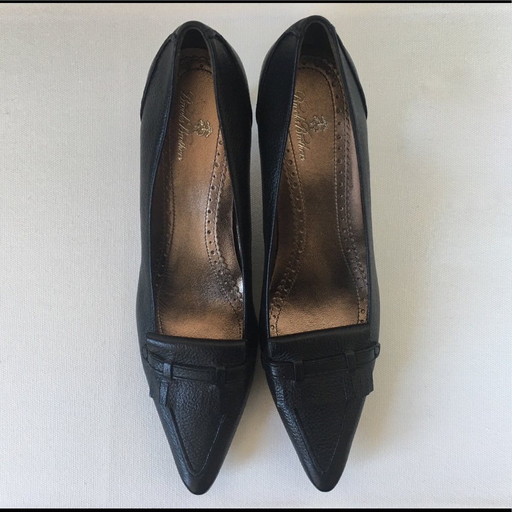 Black high heels with metallic insoles.